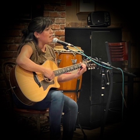 Ysela Lujan playing guitar Ysela Lujan